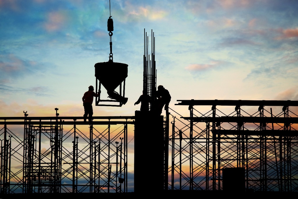 Construction engineers reviewing blueprints on-site
